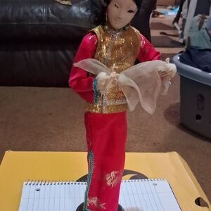 Elegant Red and Gold Decorative Doll